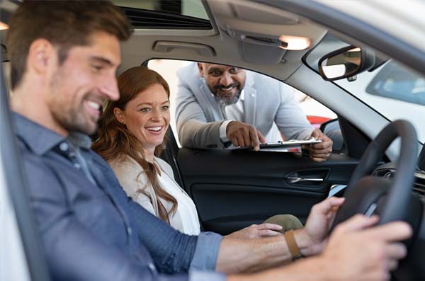 couple buying a new car